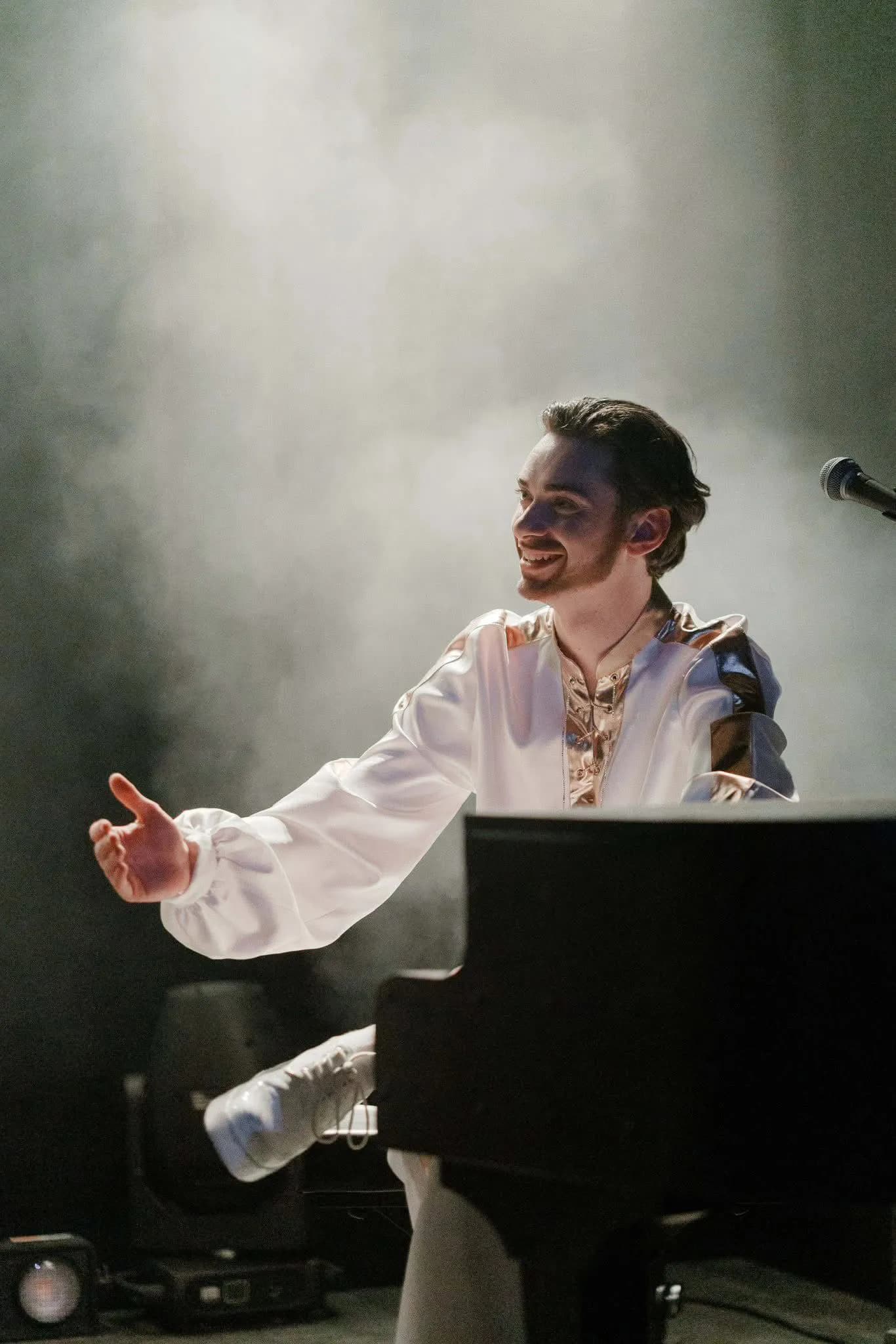 Man playing piano with smoky background