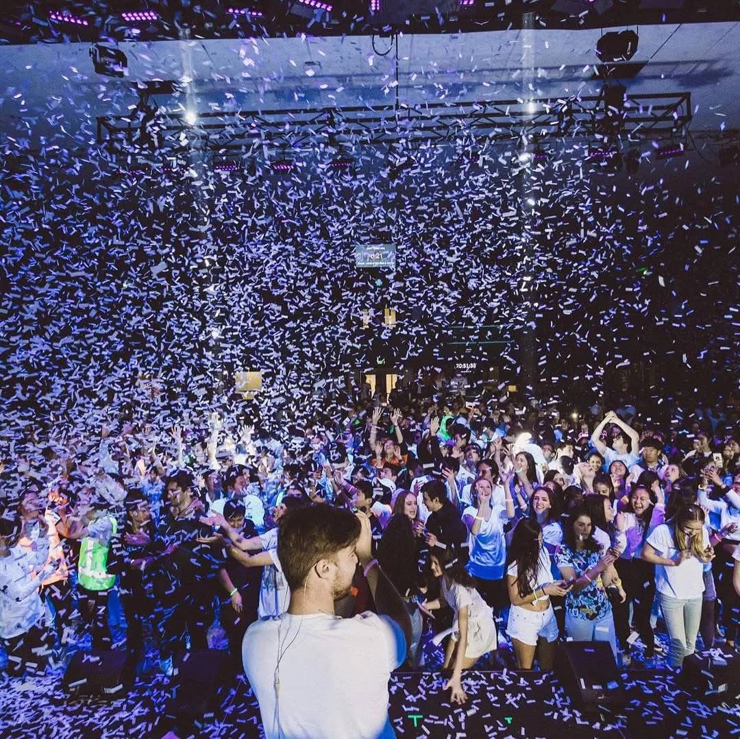 Crowd view from stage with confetti tickets